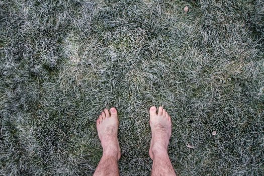 Guy barefoot on some frozen grass. This guy is weird and crazy