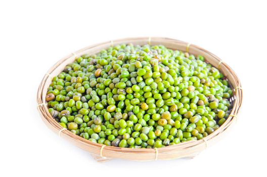 Green mung beans in weave basket on white background.