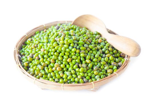 Green mung beans in weave basket on white background.