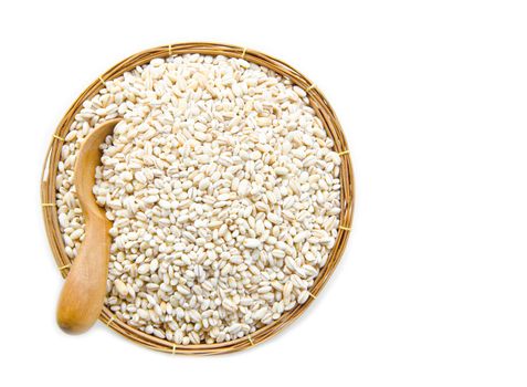 barley grit in weave basket on white background.