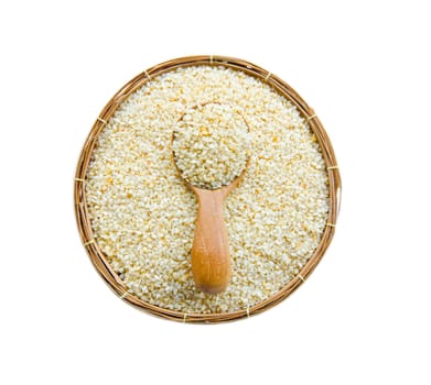 sesame seed in spoon wood and weave basket on white background.