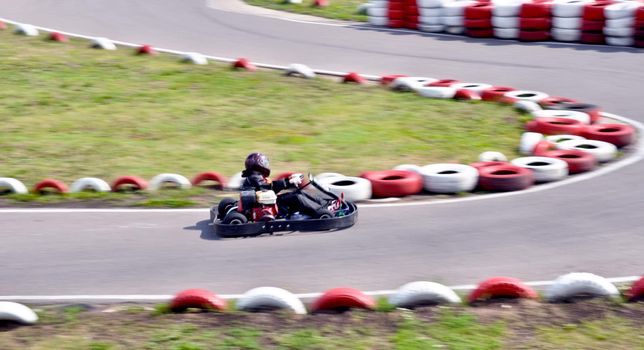 go kart racing on circuit blurry