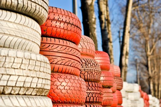 racetrack fence of white and red of old tires