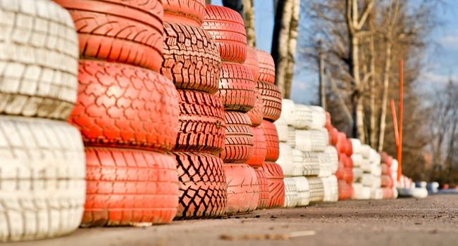 racetrack fence of white and red of old tires