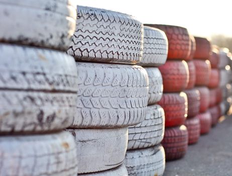 racetrack fence of white and red of old tires