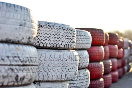 racetrack fence of white and red of old tires