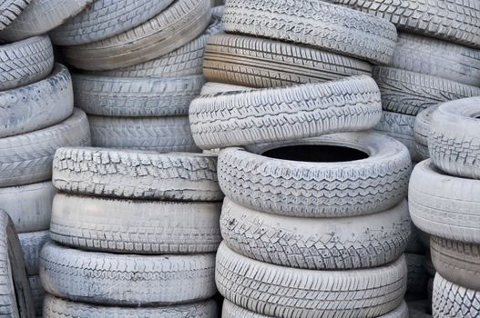 the white automobile tires dumped in a a big pile