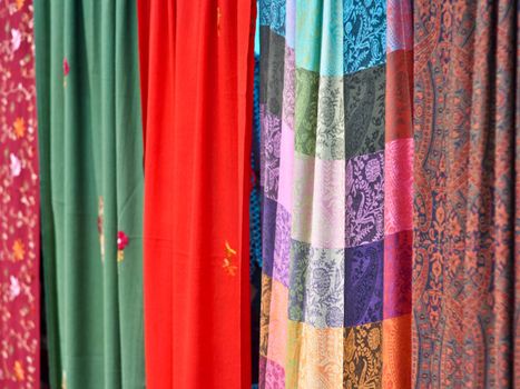 colorful patterned fabrics hanging in a row