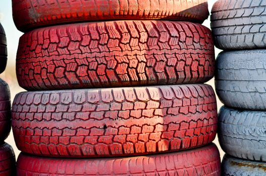 close up of racetrack fence of  red and white old tires