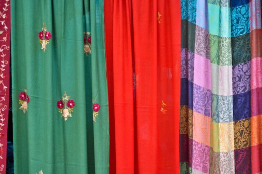 colorful patterned fabrics hanging in a row