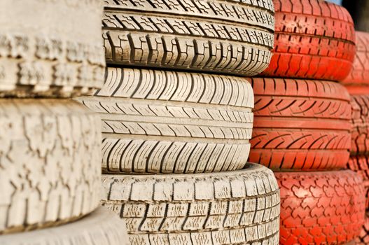 close up of racetrack fence of white and red of old tires