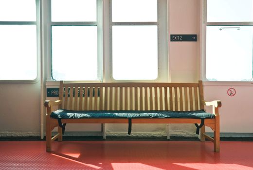 wooden bench in the interior lit by bright sunshine