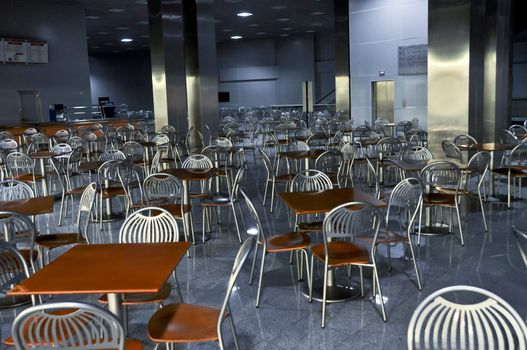 a lot of chairs and tables in fastfood cafe