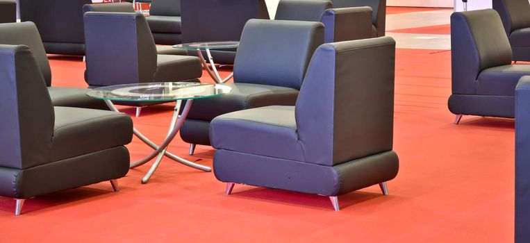 black armchairs on the red floor