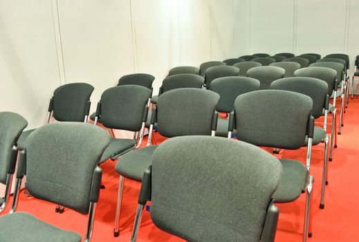 Grey chairs red floor in the Room for presentations