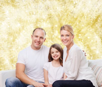 family, childhood, holidays and people - smiling mother, father and little girl over yellow lights background