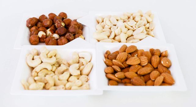various nuts mix in square paper plates