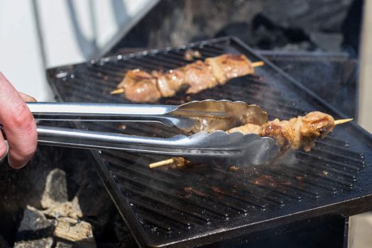 Juicy roasted kebabs on the grill in smoke