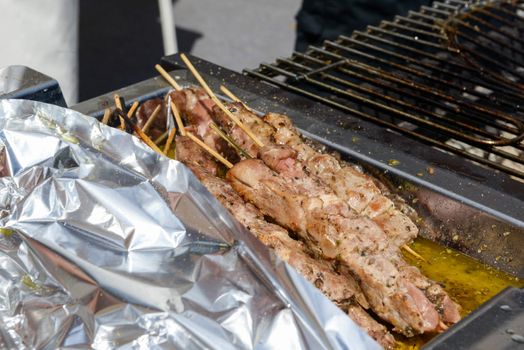 Juicy roasted kebabs on the grill in smoke