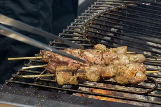 Juicy roasted kebabs on the grill in smoke