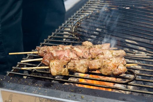 Juicy roasted kebabs on the grill in smoke