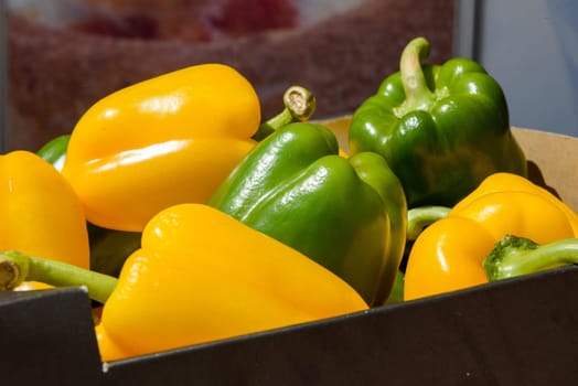 a lot of ripe clean green and yellow peppers