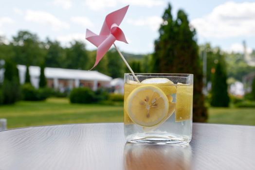 cold fresh lemonade with slices of lemon in a glass