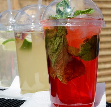 Fresh cold lemonade with mint leaves in a plastic cup