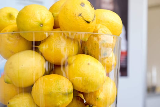 a lot of yellow ripe lemons in a glass jar