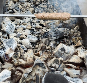 cooking meat on the hot steaming coals