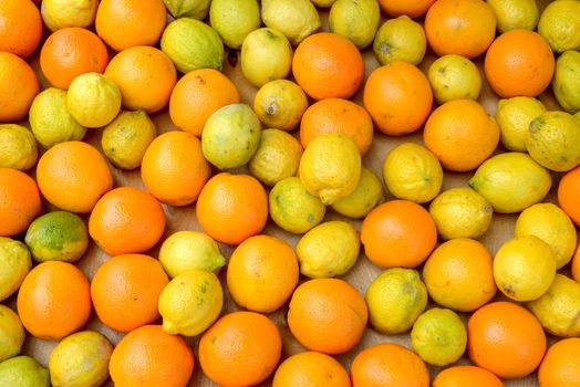 a bunch of lemons and oranges in a wooden box