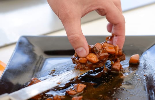 delicious freshly cooked dish of pork with sauce on the black plate