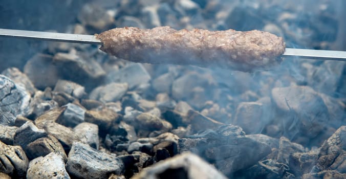 cooking meat on the hot steaming coals