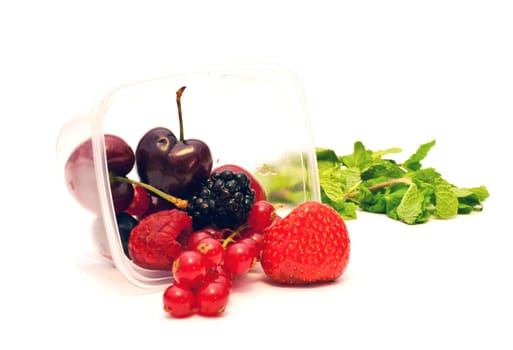 berries in a plastic box on a white background