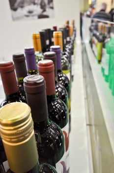 bottles with wine stand on a display.