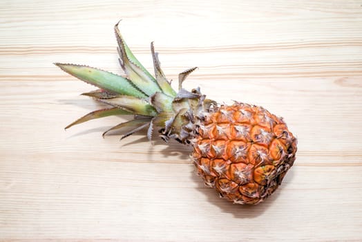 the fresh pineapple on the wooden table