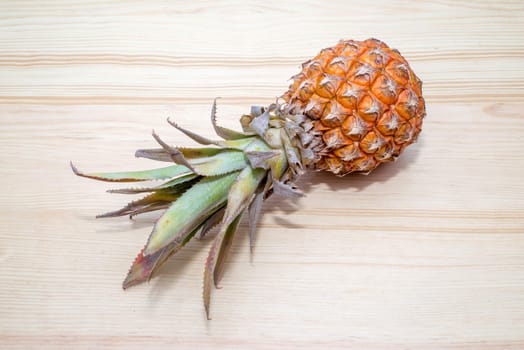 the fresh pineapple on the wooden table