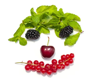 funny face from different berries on a white background