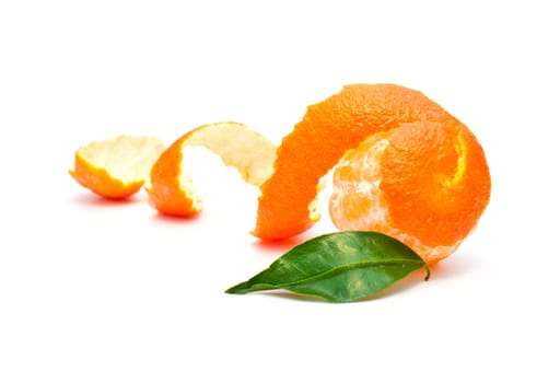 mandarin skin and green leaf on a white background isolation