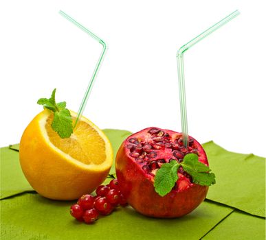 orange and pomegranate with a straw on a white background