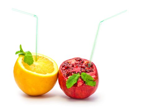 orange and pomegranate with a straw on a white background