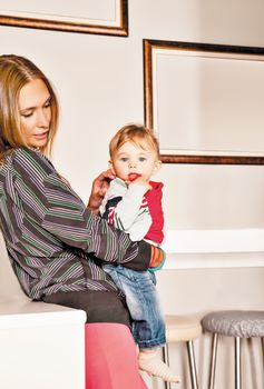 Young beautiful mother embracing her cute little boy with affection. Copy space frame.