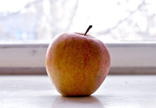 Red apple on a window sill