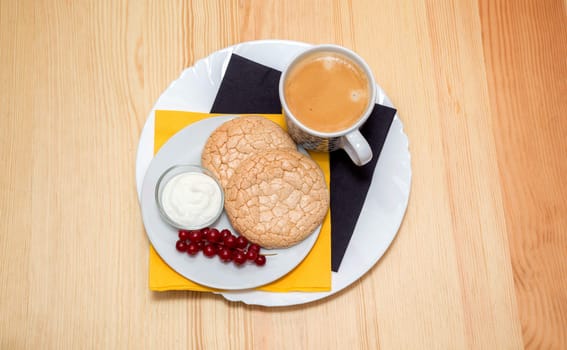 still life: a Cup of coffee and biscuits on plate on wooden table