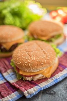 Closeup of home made burgers on wooden table