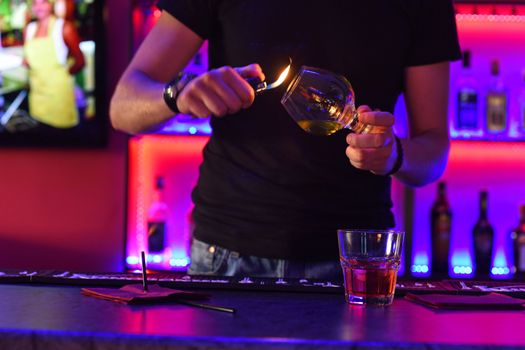Closeup photo in a bar where barmen makes cocktail
