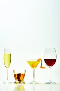 set with different drinks on white background - champagne, whiskey, cocktail, wine