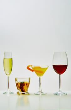 set with different drinks on white background - champagne, whiskey, cocktail, wine