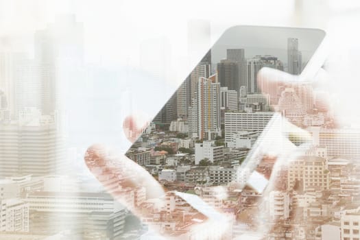 Double exposure of cityscape and smart phone, business technology concept.