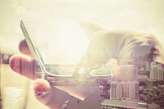 Double exposure of cityscape and smart phone, business technology concept.